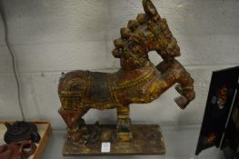 An Indian carved and painted wood model of a rearing horse.