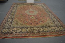 A large Persian style rug, pink ground decorated with animals, foliage and calligraphy, 400cm x