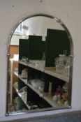 A chrome framed arch topped mirror.