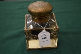 A large cut glass inkwell with metal mounts.