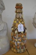 A shell encrusted bottle.