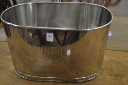 A large pair of metal champagne coolers with engraved decoration.