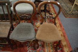 A pair of Victorian walnut balloon back dining chairs.