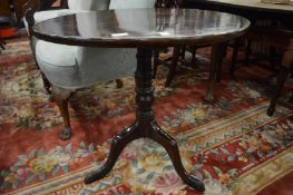 A 19th century mahogany circular tilt-top tripod table.