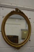 Gilt framed oval wall mirror.