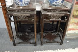 A pair of Chinese hardwood stands with pierced and carved decoration.