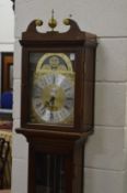 A reproduction mahogany long case clock.