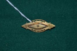 A 9ct gold and diamond brooch.