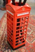 A novelty red telephone box stick stand.
