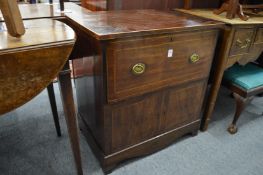 A 19th century mahogany commode with rising top and fitted interior.