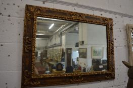 Decorative gilt framed wall mirror.