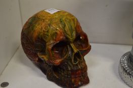 A large amber style model of a skull.
