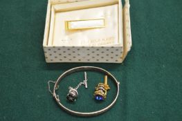 Engraved silver bracelet and other items.