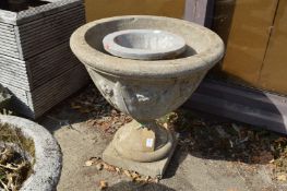 A large composite pedestal planter and another item.
