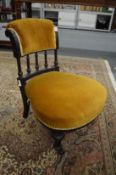 A Victorian ebonised occasional chair.