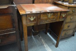 A George III mahogany three drawer writing table of small size.