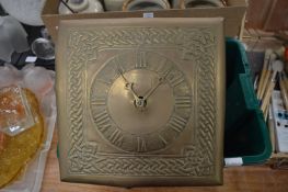 A brass wall clock.