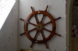 A reproduction hardwood ships wheel.
