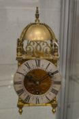 A reproduction brass lantern clock.