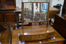 A 19th century mahogany bow front dressing table mirror with three drawers.