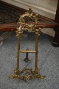 A pair of ornate brass easels.
