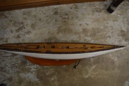 The hull of a model sailing boat.