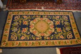 An Arts and Crafts style Continental woollen rug with floral decoration, 180cm x 95cm.
