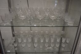 A quantity of wine and other glassware.