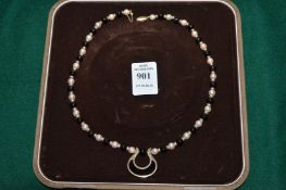 A yellow metal, enamel and bead necklace, the clasp stamped 14k.