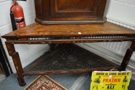 An unusual Chinese inlaid hardwood corner table with carved and pierced under tier.