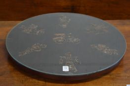 A lazy Susan, decoratively carved and inlaid with figures.