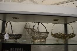 Two swing handled baskets and a wine bottle pourer.