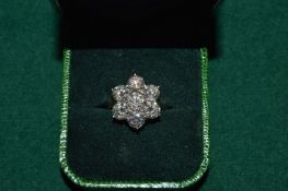A very good 18ct yellow gold and diamond seven stone flower head ring, each diamond approx half a