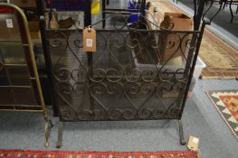A wrought iron fire guard.