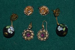 Three pairs of decorative earrings.