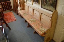 A 19th century pine pew, 225cm long.