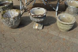 Three various weathered composite stone planters.