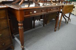 A Victorian mahogany two drawer side table on turned and reeded legs.