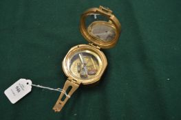 A reproduction brass compass.