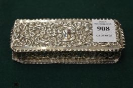 An embossed silver box with hinged cover.