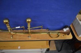 Copper hunting horn, a brass model of a cutlass and a pair of brass fire dogs.