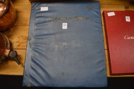 A scrap album containing numerous postcards and photographs of early cars, trains etc.