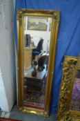 A Victorian style gilt framed narrow mirror.