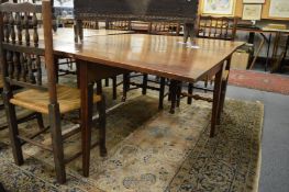 A 19th century oak drop-leaf gateleg dining table.