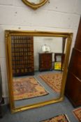 A large Victorian style gilt framed wall mirror.