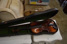 A cased violin and bow.