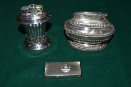 Two table lighters and a cigar cutter.