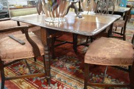 A 19th century mahogany drop-leaf gateleg dining table on turned legs.