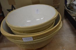 Four old mixing bowls.