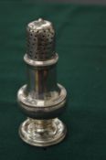 A silver pedestal pepperette.
